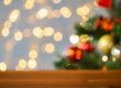 empty wooden surface over christmas tree lights