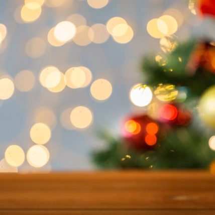 empty wooden surface over christmas tree lights empty wooden surface over christmas tree lights