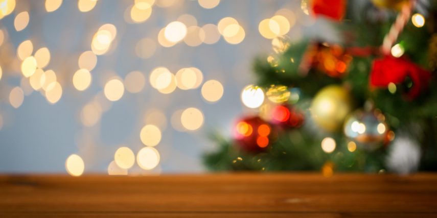 empty wooden surface over christmas tree lights