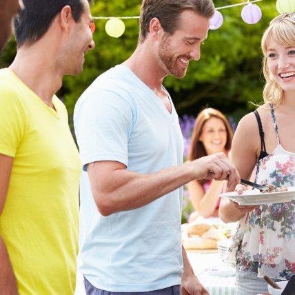 Group Of Friends Having Outdoor Barbeque At Home life insurance at misner agency