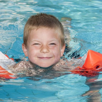 Smiling boy enjoying the swimming pool Smiling boy enjoying the swimming pool