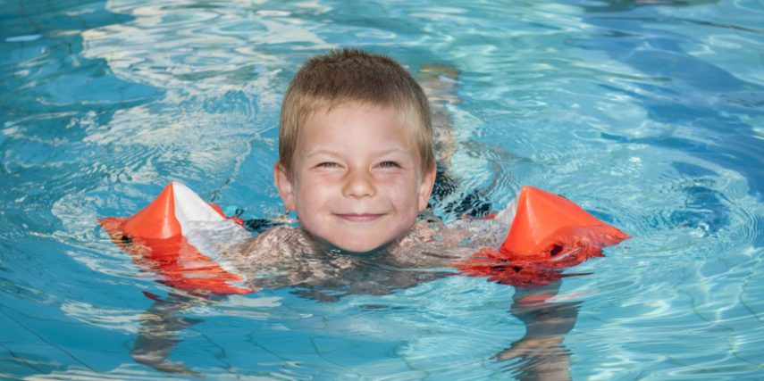 Smiling boy enjoying the swimming pool Smiling boy enjoying the swimming pool