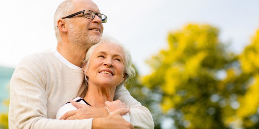 senior couple hugging in park Life insurance