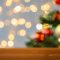 empty wooden surface over christmas tree lights